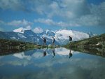 Hikers passing a mountain lake, Tuxertal area, Austria photo