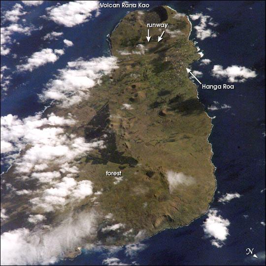 Easter Island, one of the most remote locations on Earth, is more than 3,200 km (2,000 mi) from the closest populations on Tahiti or Chile. Less than 25 km (15 mi) long, the island is dominated by volcanic landforms, including the large crater Rana Kao at the southwest end of the island and a line of cinder cones that stretch north from the central mountain. A final feature (difficult to see) is the very long runway (Chile's longest) near Rana Kao. The airport serves as an emergency space shuttle landing site. Image courtesy of NASA.