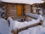 Hot tubbing outside a log house, Finland photo